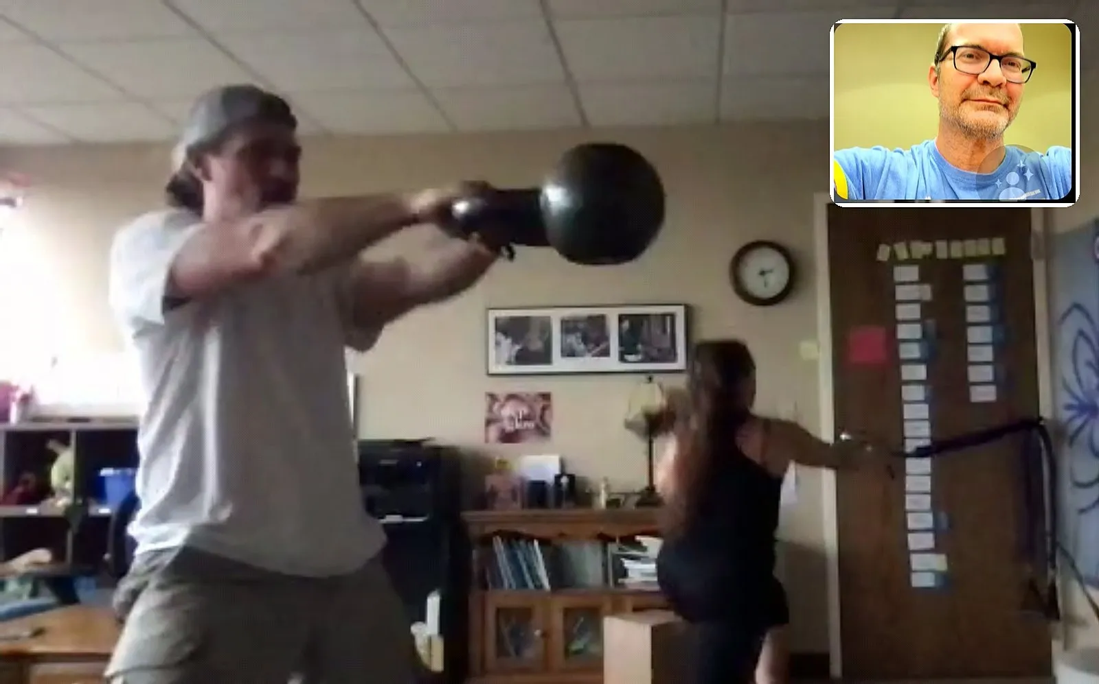 A client training with a kettlebell in her home office during a Zoom session with Jamie Atlas