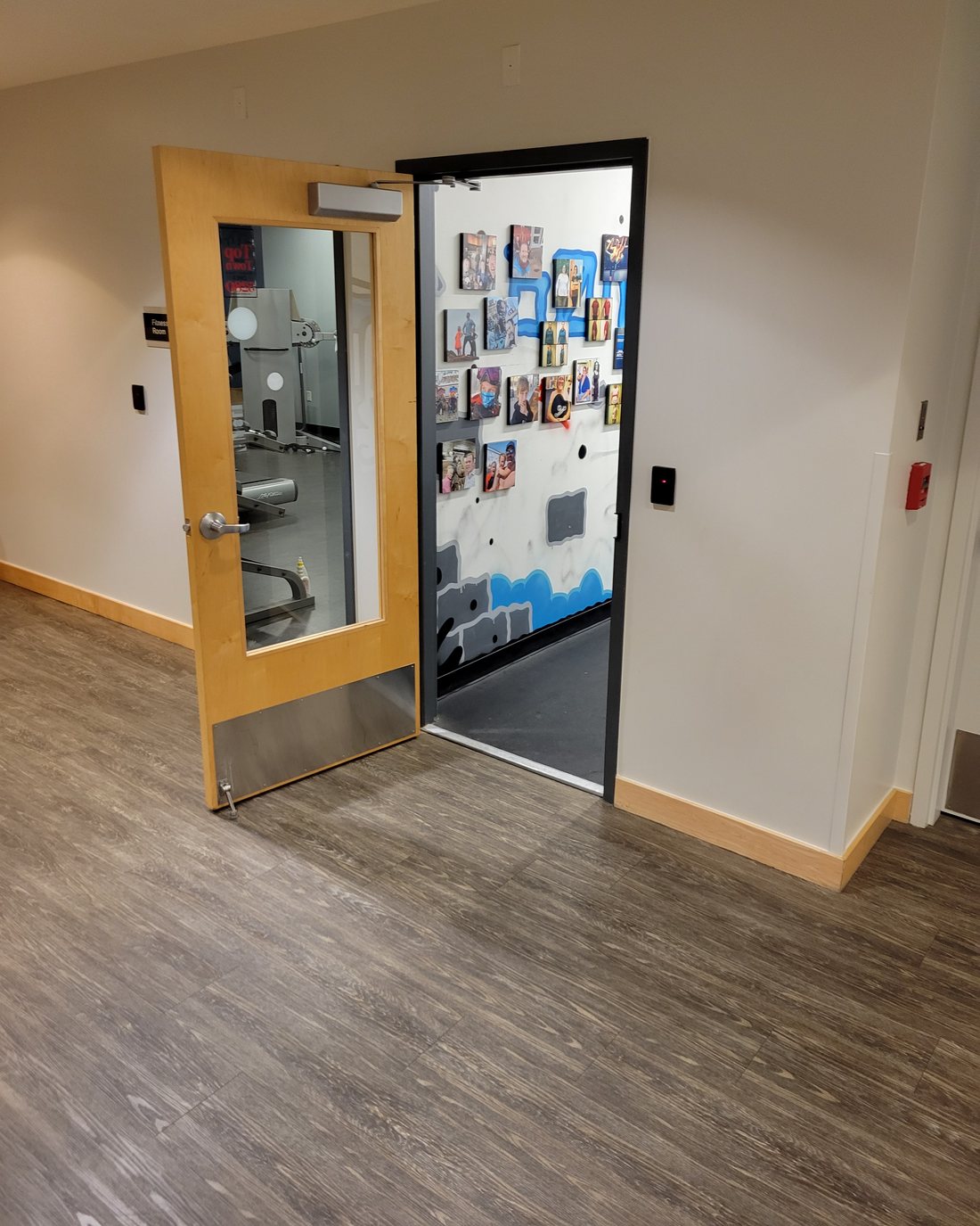 The studio door on the basement level, with the graffiti wall and client photos visible inside