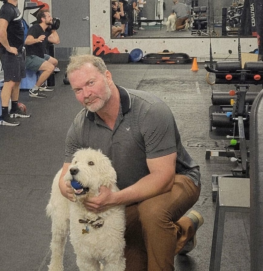 Jamie Atlas with a client's dog on the studio floor mid-session