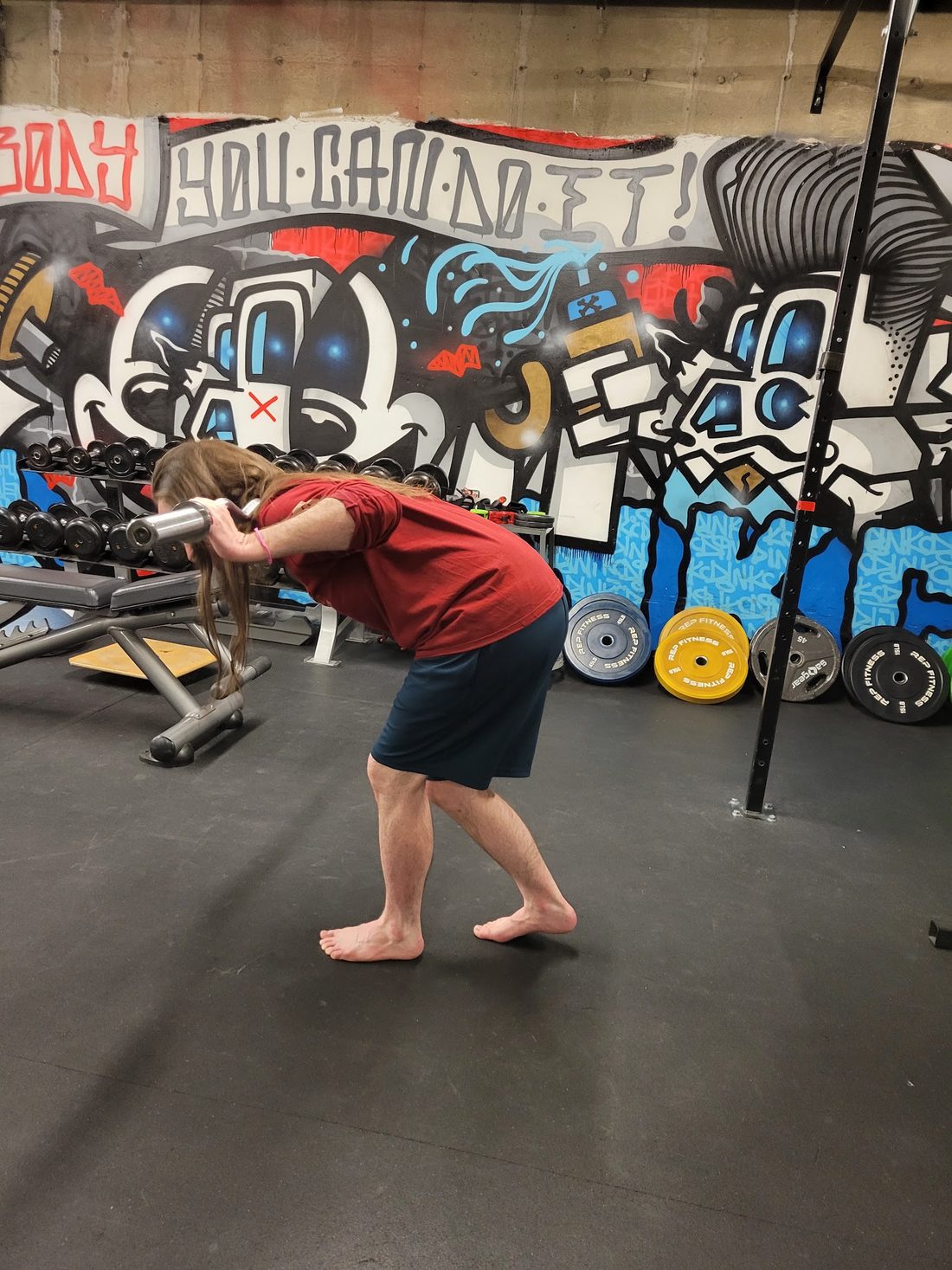 A client working through a loaded hinge pattern in the Jamie Atlas Rehab studio
